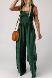 Green smocked square neck wide leg jumpsuit with spaghetti straps.