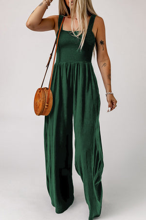 Green smocked square neck wide leg jumpsuit with spaghetti straps.