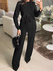 Black long sleeve top and wide leg pants with drawstring waist.