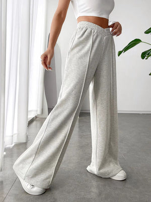 Light gray V-waistline palazzo sweatpants with center seams and wide legs.