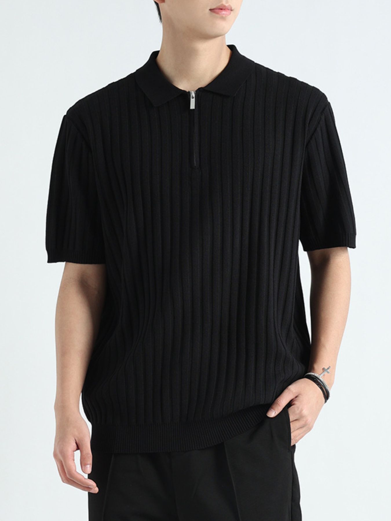 Black ribbed knit polo shirt with short sleeves and a quarter-zip neckline.