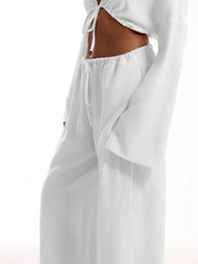 White maternity wide-leg pants with drawstring waist and relaxed fit.