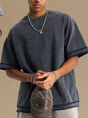 Washed cotton t-shirt in dark gray with raw edges and a relaxed fit.