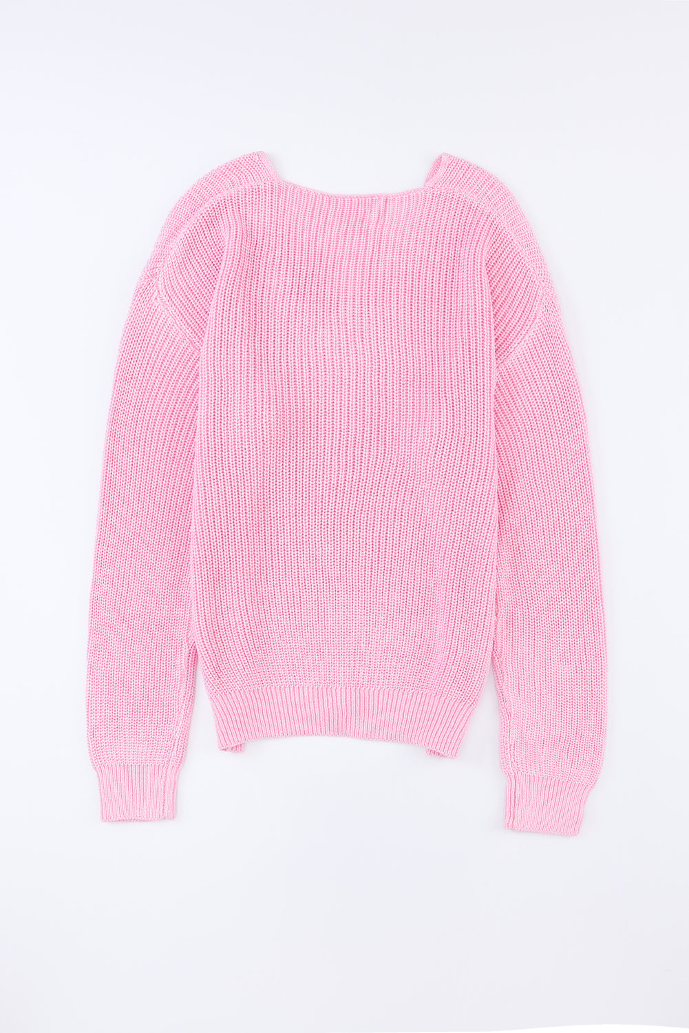 Relaxed knit V-neck pullover sweater in blush pink acrylic with ribbed texture and long sleeves.