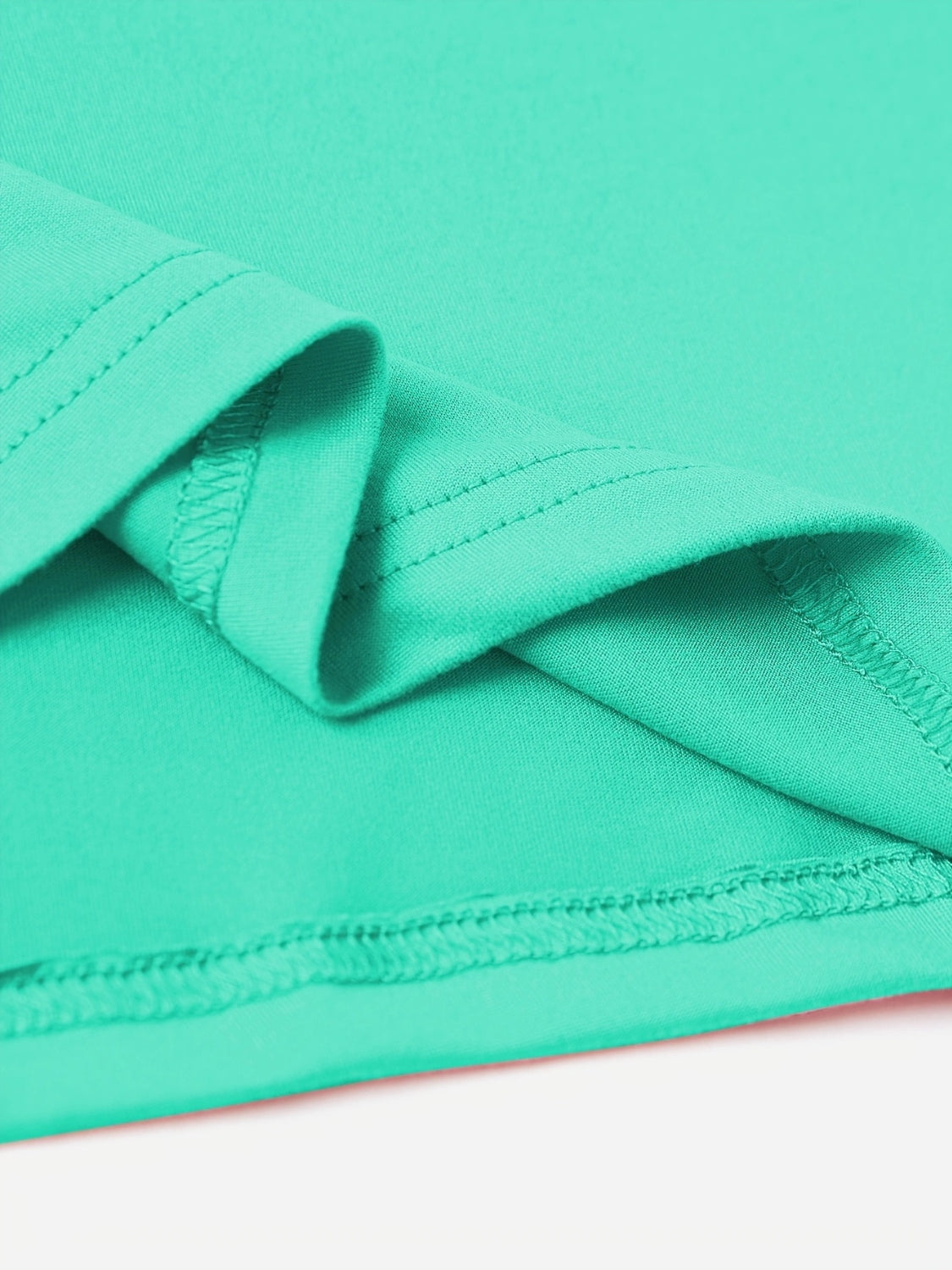 Tiffany blue t-shirt detail showing hem stitching and fabric texture