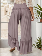 Mauve wide-leg pants with ruffle trim at the waist and hem.
