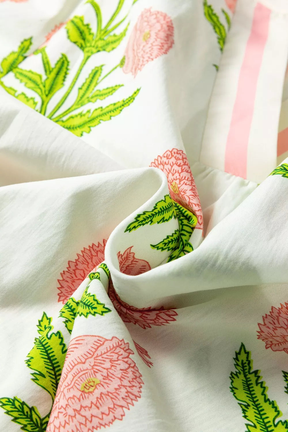 Cotton blouse with vibrant pink floral print and ruffled sleeve detail.