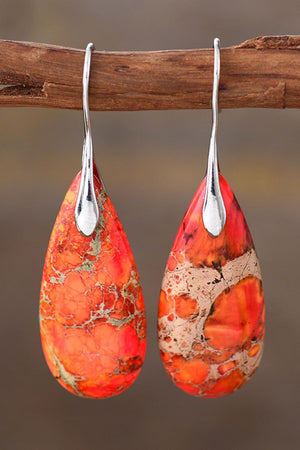 Ocean Jasper dangle earrings with silver hooks and teardrop stones in red and orange hues.