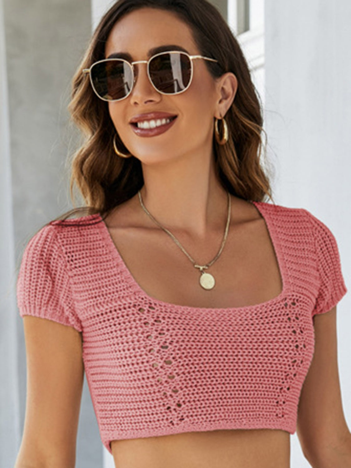 Crochet crop top in blush pink with square neckline and short sleeves.