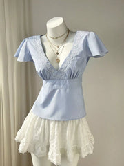 Blue pinstripe polyester blouse with lace V-neck and flutter sleeves.