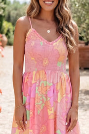 Smocked floral print cotton dress with ruffled neckline and spaghetti straps.