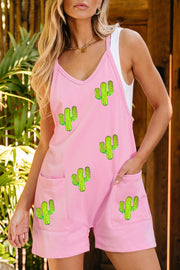 Blush pink romper with cactus patches, V-neck, spaghetti straps, and pockets.
