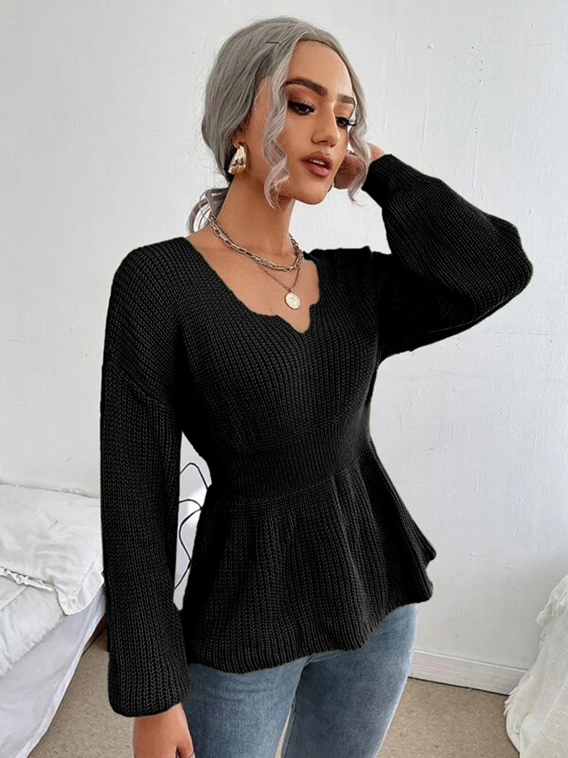 Black peplum knit sweater with scallop neckline and long sleeves