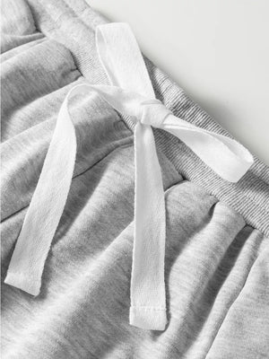 Grey cotton drawstring lounge set detail with white tie and lace trim.