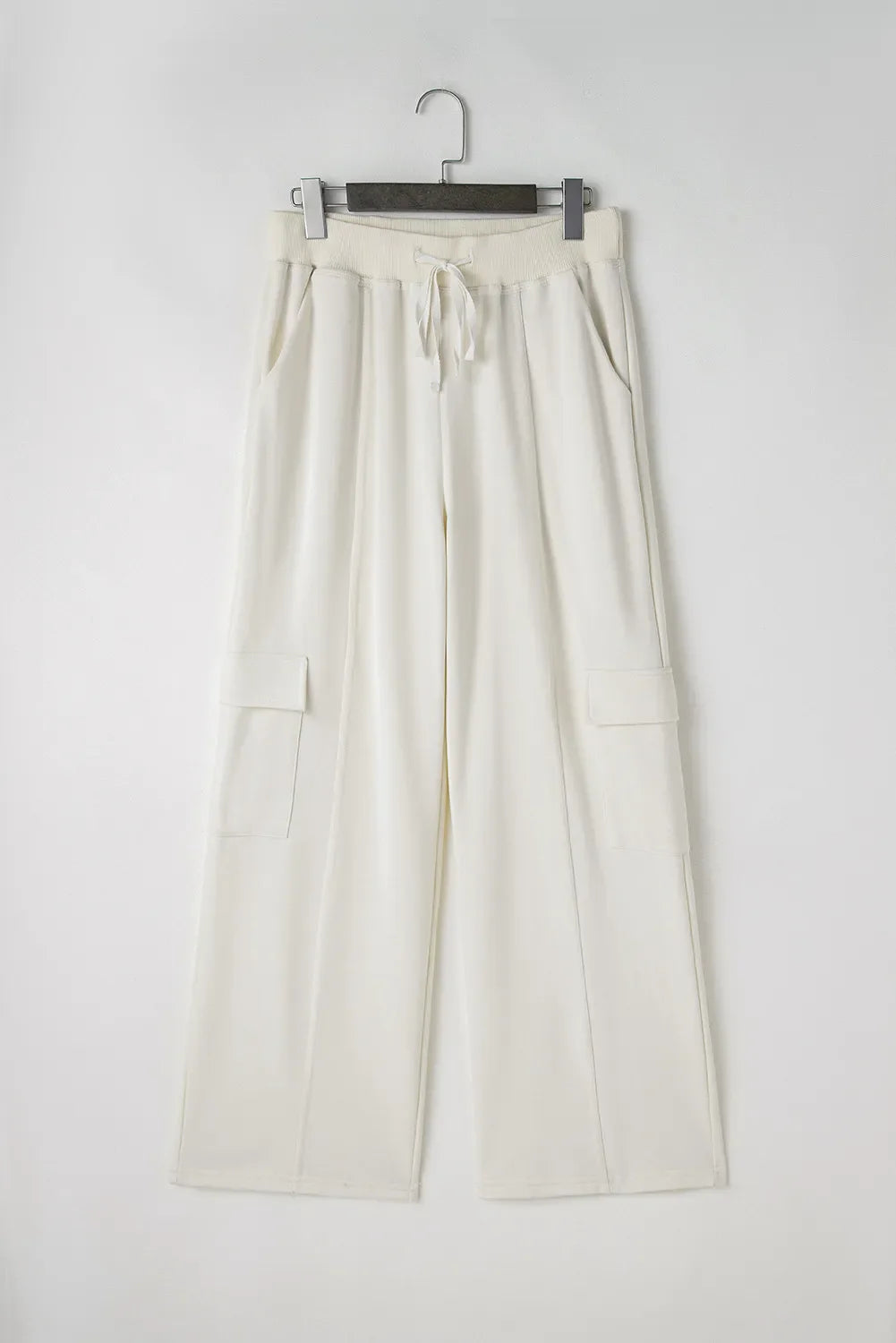 Ivory wide leg cargo pants with drawstring waist and side cargo pockets.