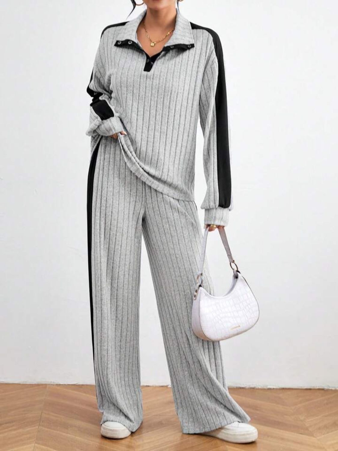 Light gray ribbed polo lounge set with black contrast trim and wide leg pants.