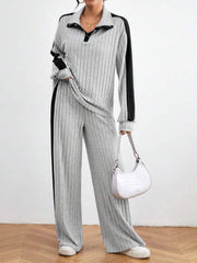 Light gray ribbed polo lounge set with black contrast trim and wide leg pants.