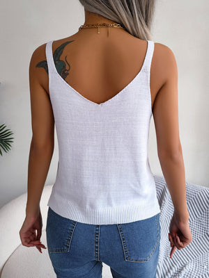 White knit tank top with V-neck and ribbed hem, styled with jeans.