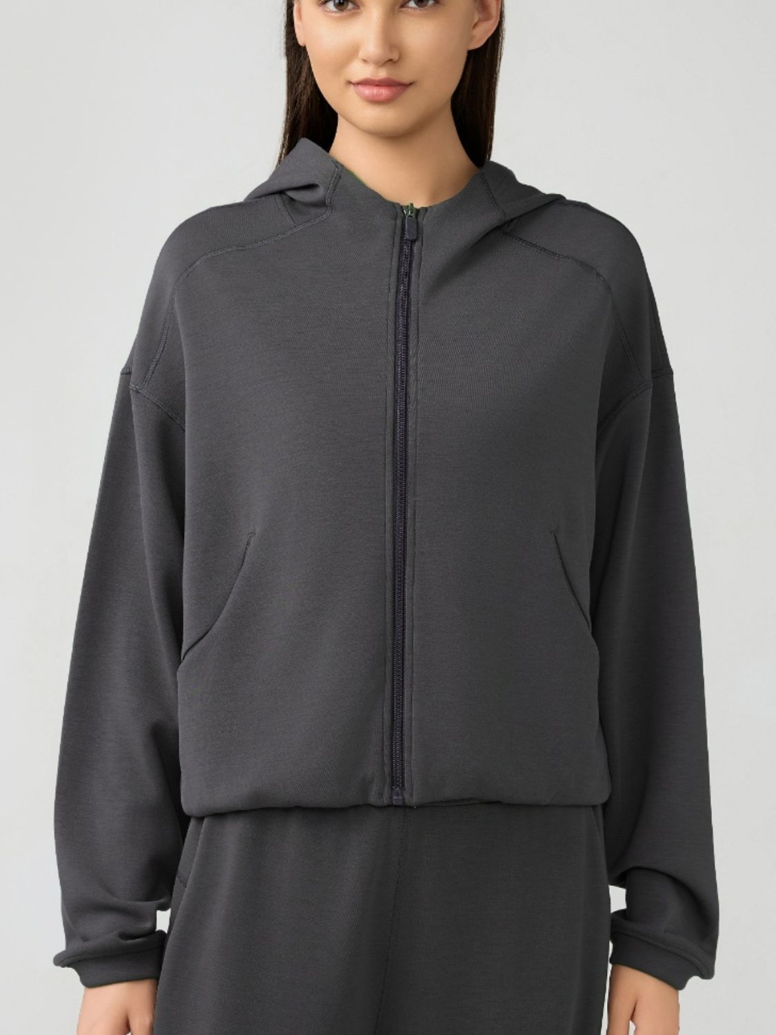 Dark gray cropped active hoodie with zipper, raglan sleeves, and pockets