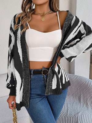 Zebra stripe open-front knit cardigan in black and white acrylic with a relaxed fit.