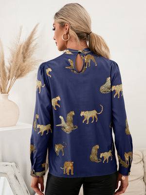 Royal blue leopard print blouse with keyhole neck detail and puff sleeves.