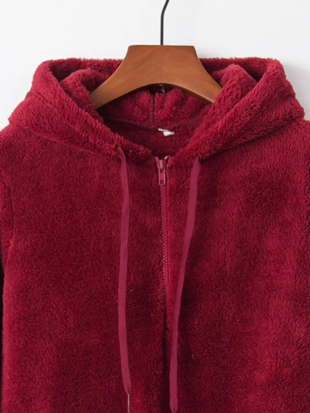 Burgundy half-zip fleece hoodie with drawstring and hood.