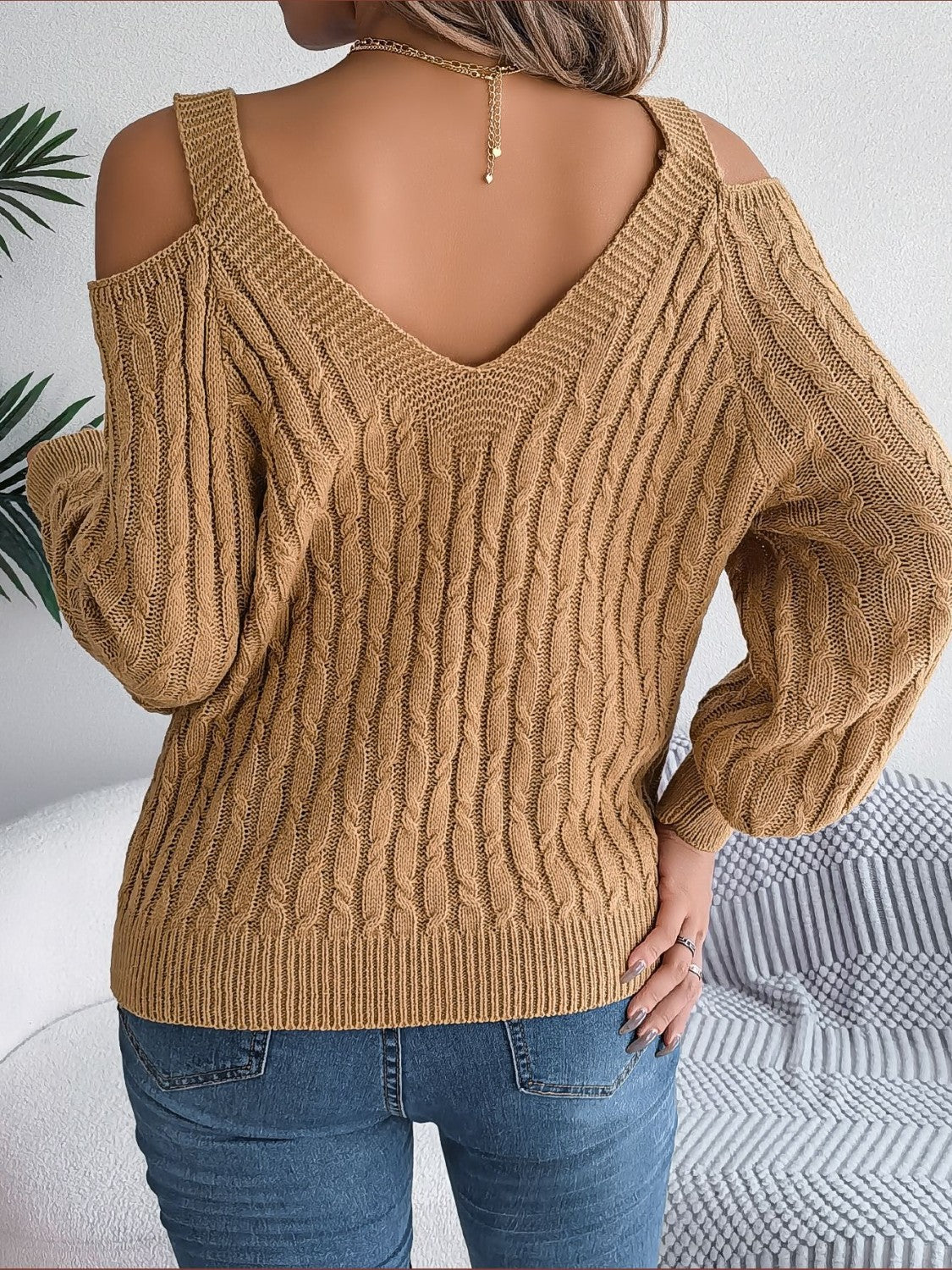 Taupe cable knit cold shoulder sweater with V-neck and balloon sleeves.