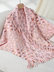 Blush pink acrylic shawl cardigan with textured pattern and fringe details