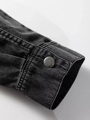Black denim button-up dress with raw hem detail and silver button cuff.