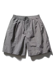 Men's gray textured drawstring shorts with elastic waist and subtle logo detail.