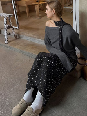 Black polka dot skirt with a grey one shoulder top and polka dot detail.