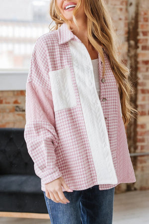 Panelled houndstooth quilted shacket in dusty pink with white cable knit details and a collared neckline.