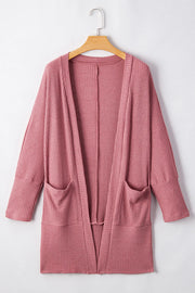 Dusty pink waffle knit open front cardigan with pockets and long sleeves.