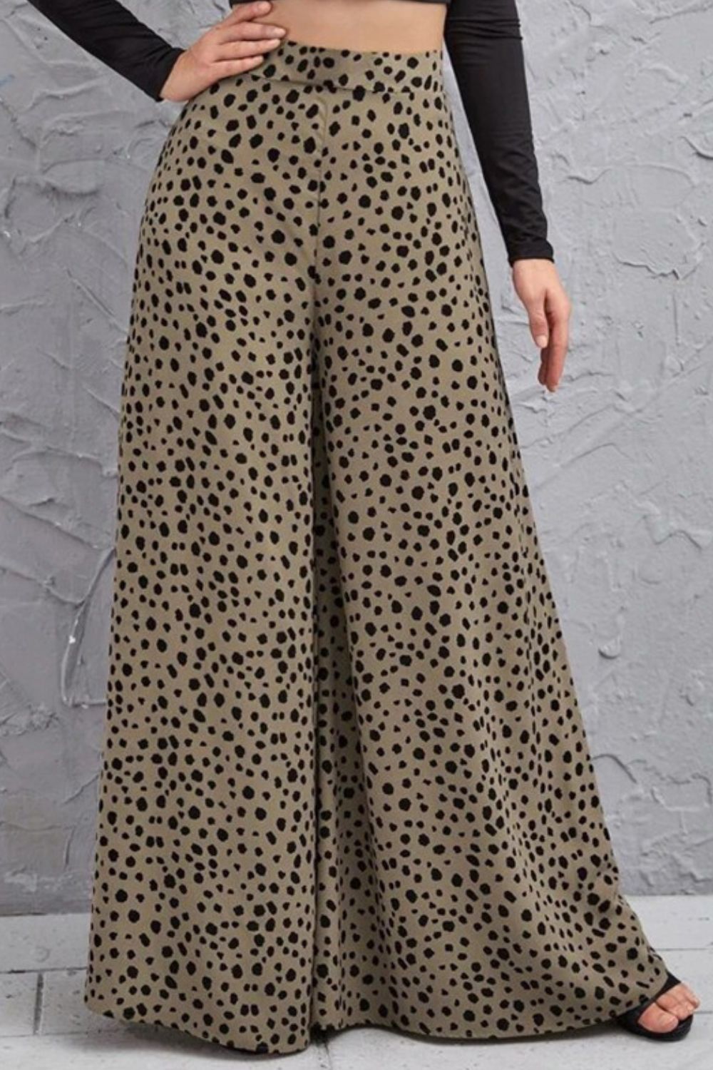 Spotted wide-leg palazzo trousers in a neutral tone with black animal print.