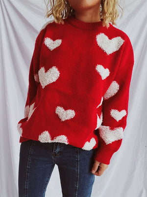 Red acrylic knit sweater with textured white heart appliqués.