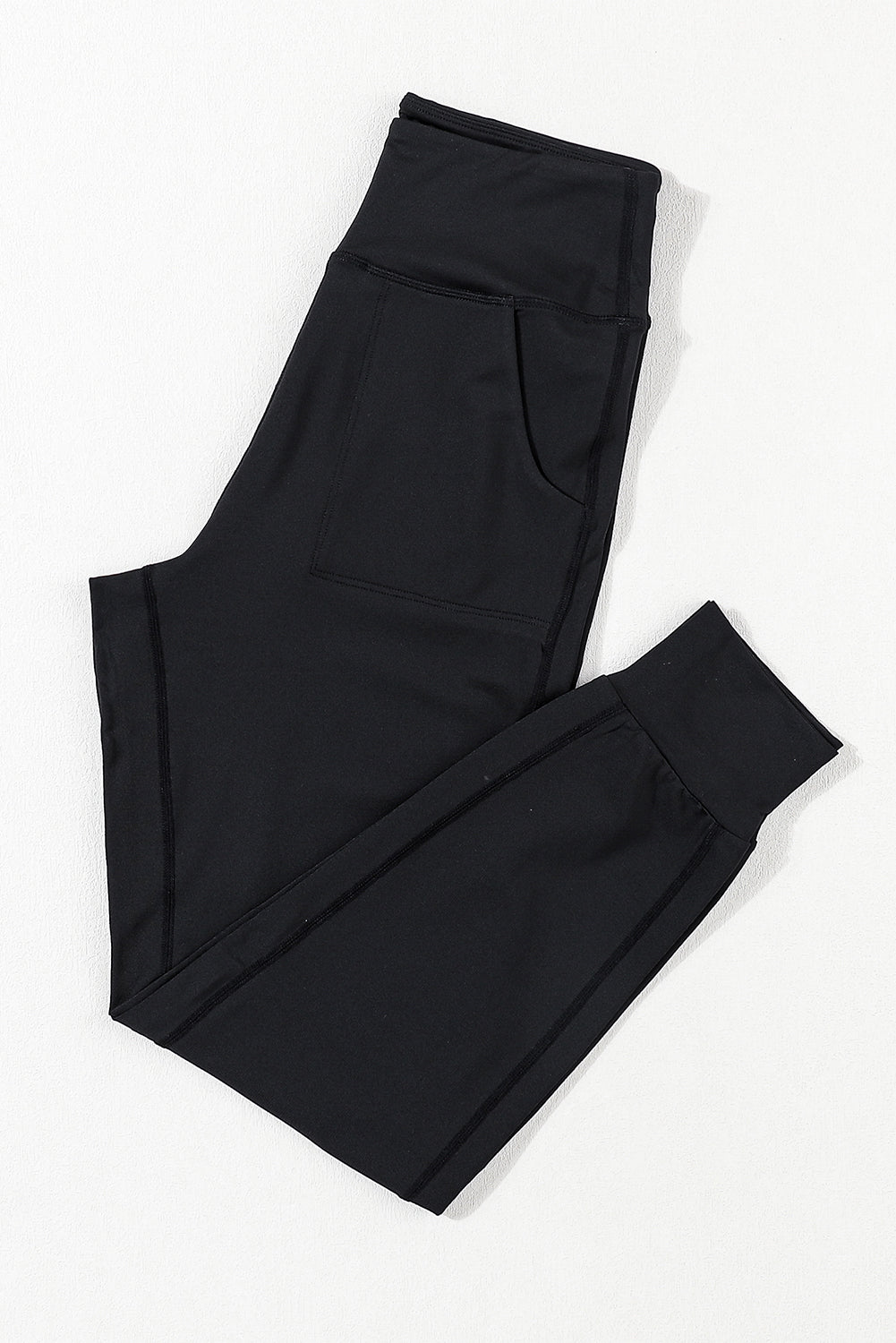Black joggers with performance fit, pockets, and cuffed ankles.
