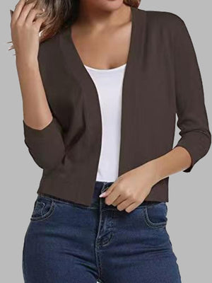 Cropped elbow-sleeve open-front knit cardigan in chocolate brown, worn over a white tank top.