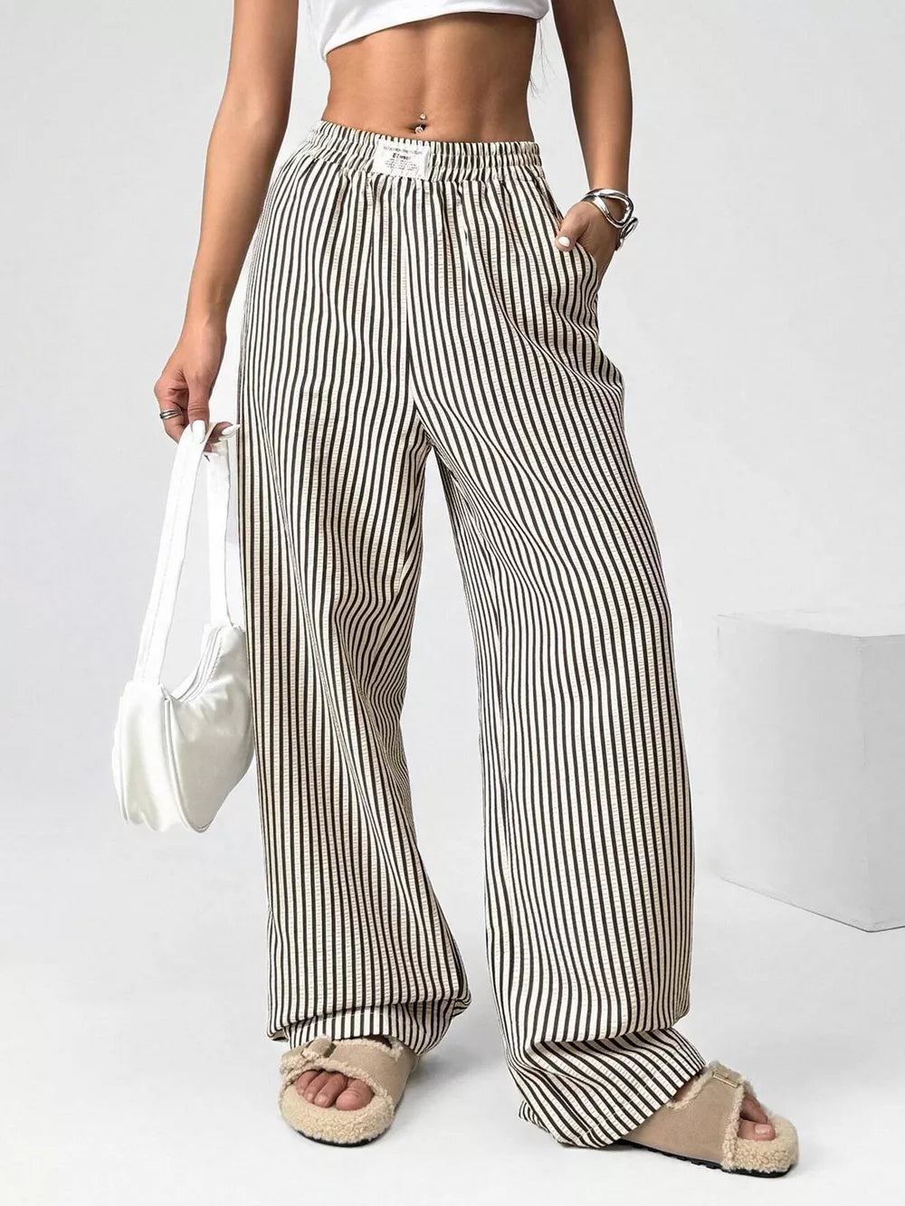 Navy striped high-waisted wide-leg pants with drawstring waist and pockets.