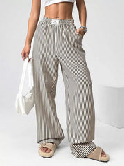 Navy striped high-waisted wide-leg pants with drawstring waist and pockets.