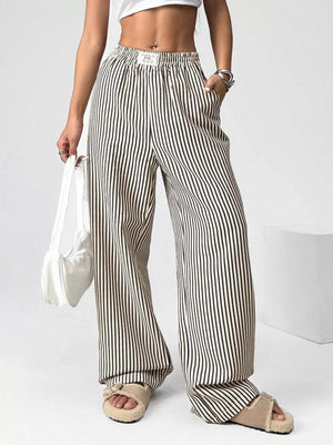 Navy striped high-waisted wide-leg pants with drawstring waist and pockets.