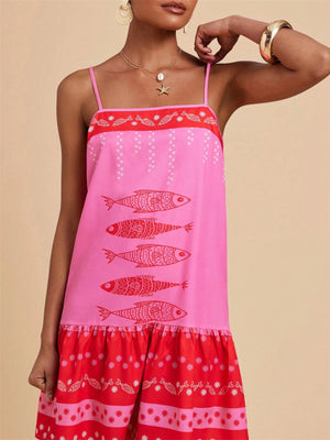 Pink spaghetti strap mini dress with red fish print and tiered ruffle hem.
