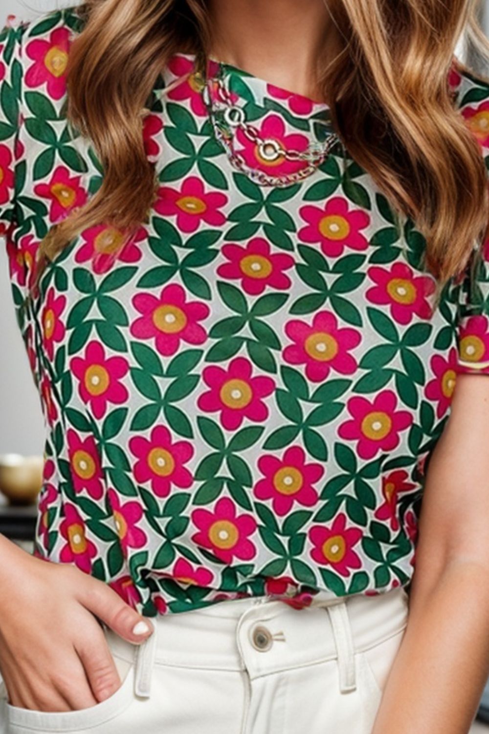 Floral tee with scallop trim and chain detail at the neckline.