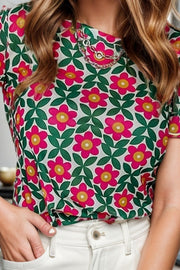Floral tee with scallop trim and chain detail at the neckline.