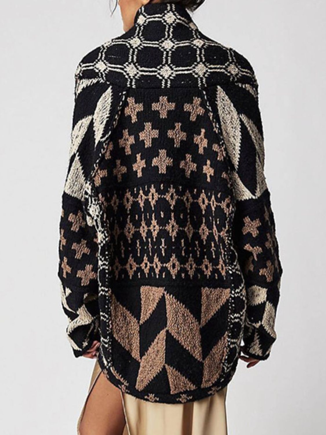 Geometric patchwork knit cardigan in black and tan with a buttoned front and collar.