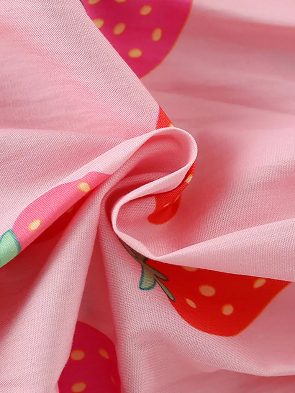 Baby dress in pink cotton blend with allover strawberry print and puff sleeve detail.