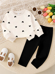 Baby top and pants set with black heart print on cream top and ribbed black pants