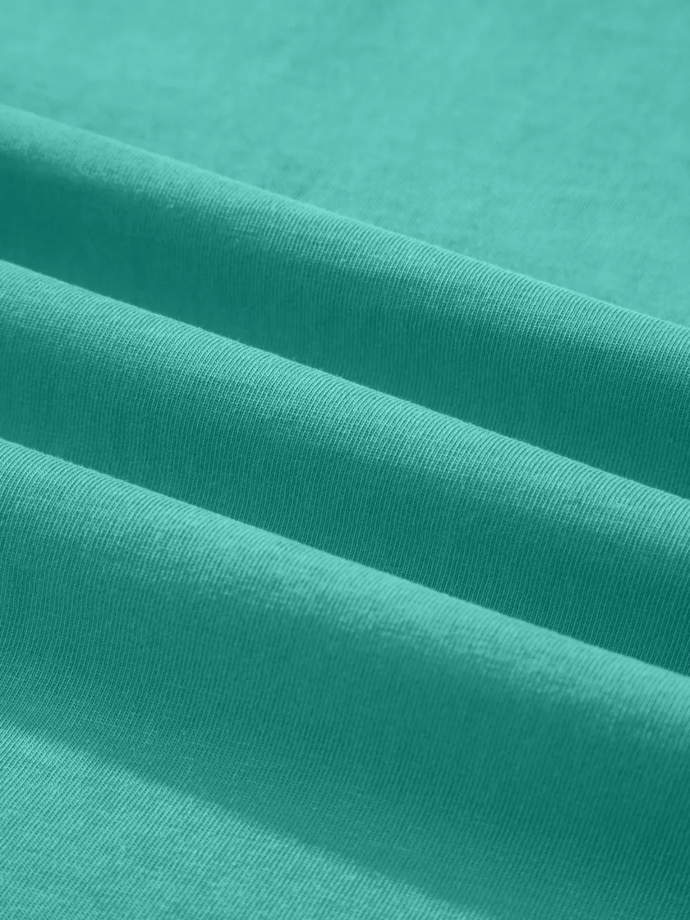 Teal mineral wash cotton tee with soft texture and subtle ribbing detail.