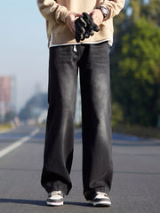 Black relaxed fit 100% cotton jeans with a drawstring waist.
