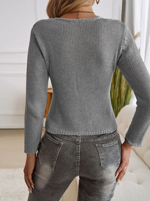 Gray knit cropped cardigan with long sleeves and a keyhole detail, shown from the back.