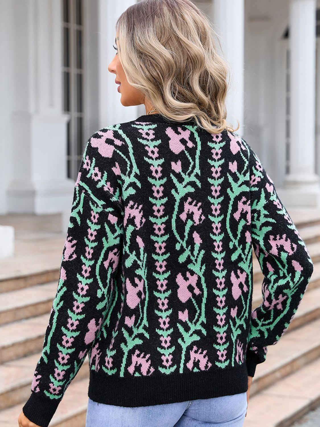 Black crewneck sweater with pink and green floral tapestry pattern, acrylic knit.